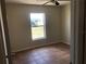 A modest bedroom featuring tile floors and a window looking out onto the front yard at 77 Dogwood Drive Pass, Ocala, FL 34472