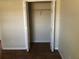 Walk-in closet with shelving, white trim and tile flooring at 77 Dogwood Drive Pass, Ocala, FL 34472