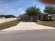 Charming single-story home with a well-maintained lawn and a long driveway at 77 Dogwood Drive Pass, Ocala, FL 34472