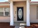 Close-up of the front door entrance with decorative glass and white pillars at 77 Dogwood Drive Pass, Ocala, FL 34472
