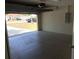 Open garage leading to a well-maintained front yard, providing convenient access and curb appeal at 77 Dogwood Drive Pass, Ocala, FL 34472