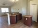 The kitchen features brown cabinets, a sink, and an island at 77 Dogwood Drive Pass, Ocala, FL 34472