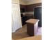 Compact kitchen featuring dark appliances, brown cabinets, island, and tile flooring at 77 Dogwood Drive Pass, Ocala, FL 34472