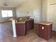 Open concept kitchen with stainless steel sink and brown cabinets at 77 Dogwood Drive Pass, Ocala, FL 34472