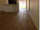 The living room and kitchen have tile flooring and sliding glass doors at 77 Dogwood Drive Pass, Ocala, FL 34472