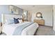 This primary bedroom features a light blue accent wall, soft carpet and modern fixtures at 8407 Gower Trl, Wildwood, FL 34785