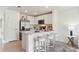 Bright kitchen featuring stainless steel appliances and a quartz breakfast bar at 8407 Gower Trl, Wildwood, FL 34785