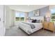 Bright bedroom featuring a large window with scenic water views, soft carpet and neutral color palette at 8411 Gower Trl, Wildwood, FL 34785