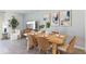 Bright dining room with a stylish table setting, perfect for hosting gatherings, adjacent to the living area at 8411 Gower Trl, Wildwood, FL 34785
