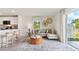 Bright living area with woven chairs, modern sofa and lots of natural light at 8415 Gower Trl, Wildwood, FL 34785