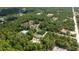 Expansive aerial view of a home nestled among lush greenery and mature trees at 8498 Sw 129Th Terrace Rd, Dunnellon, FL 34432