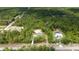 Aerial view of the home nestled among lush greenery, showcasing its serene and private setting at 8498 Sw 129Th Terrace Rd, Dunnellon, FL 34432