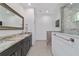 Bathroom features a double sink vanity, a large mirror, and a walk-in shower at 8498 Sw 129Th Terrace Rd, Dunnellon, FL 34432