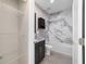 Bathroom with marble tiling in the shower, granite countertop, and wire shelving at 8498 Sw 129Th Terrace Rd, Dunnellon, FL 34432