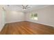 Spacious bedroom featuring hardwood floors, ceiling fan and a bright window at 8498 Sw 129Th Terrace Rd, Dunnellon, FL 34432