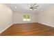 Bedroom features hardwood floors, ceiling fan, a bright window, and natural light at 8498 Sw 129Th Terrace Rd, Dunnellon, FL 34432