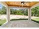Beautiful covered patio features a tile floor, ceiling fan, and a relaxing view of the backyard at 8498 Sw 129Th Terrace Rd, Dunnellon, FL 34432