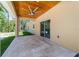 Large covered patio with stone flooring, ceiling fan, and sliding glass doors at 8498 Sw 129Th Terrace Rd, Dunnellon, FL 34432