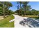 Concrete driveway leads to a home surrounded by mature trees in a serene setting at 8498 Sw 129Th Terrace Rd, Dunnellon, FL 34432
