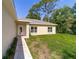 Side view of charming single story home with tiled walkway and tidy landscaping at 8498 Sw 129Th Terrace Rd, Dunnellon, FL 34432