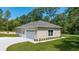 Detached two-car garage with paved driveway and tidy landscaping at 8498 Sw 129Th Terrace Rd, Dunnellon, FL 34432