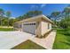 Detached two-car garage with concrete driveway and tidy landscaping at 8498 Sw 129Th Terrace Rd, Dunnellon, FL 34432