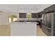 Well-lit kitchen with stainless steel appliances, granite counters, dark cabinets, and open layout at 8498 Sw 129Th Terrace Rd, Dunnellon, FL 34432