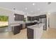 Spacious kitchen featuring stainless steel appliances, granite countertops, and dark cabinetry at 8498 Sw 129Th Terrace Rd, Dunnellon, FL 34432