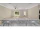 Close-up of kitchen island with granite countertop, electrical outlets, and an open floor plan at 8498 Sw 129Th Terrace Rd, Dunnellon, FL 34432