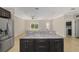Kitchen island with granite countertop, dark wood cabinetry, and stainless steel refrigerator at 8498 Sw 129Th Terrace Rd, Dunnellon, FL 34432