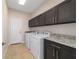 Well-equipped laundry room with washer, dryer, ample cabinet storage, and granite countertops at 8498 Sw 129Th Terrace Rd, Dunnellon, FL 34432
