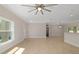 Bright, open-concept living room featuring tile flooring, neutral paint, and a modern ceiling fan at 8498 Sw 129Th Terrace Rd, Dunnellon, FL 34432