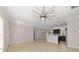 Open living area leading to the kitchen, featuring tile floors, recessed lighting, and modern fixtures at 8498 Sw 129Th Terrace Rd, Dunnellon, FL 34432