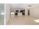 Bright, open-concept living space with tile floors and view to kitchen at 8498 Sw 129Th Terrace Rd, Dunnellon, FL 34432