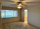 Bedroom featuring a large window and neutral carpet, with an ensuite bathroom providing lots of convenience at 9314 Sw 90Th St, Ocala, FL 34481