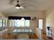 Bright dining room with hardwood floors, a ceiling fan, and views of the backyard at 9314 Sw 90Th St, Ocala, FL 34481