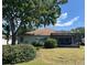 Rear exterior of the home featuring a screened-in patio and well-manicured landscaping, creating an inviting outdoor space at 9314 Sw 90Th St, Ocala, FL 34481