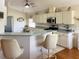 Bright and airy kitchen with stainless steel appliances, ample cabinetry, and a cozy breakfast bar at 9314 Sw 90Th St, Ocala, FL 34481