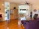 Bright living room with hardwood floors, ceiling fan, and an open view to the kitchen and dining area at 9314 Sw 90Th St, Ocala, FL 34481
