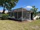 Spacious screened-in patio with ample seating, overlooking a well-maintained yard, ideal for outdoor living at 9314 Sw 90Th St, Ocala, FL 34481