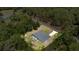 Aerial perspective displays a home with a screened pool, complemented by expansive greenery and mature trees at 9835 Sw 207Th Cir, Dunnellon, FL 34431