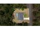 An aerial view capturing the home with a pool and a detached shed, set on a spacious lot with a long driveway at 9835 Sw 207Th Cir, Dunnellon, FL 34431