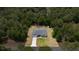 Aerial view of home with lush landscaping, backyard pool, and shed at 9835 Sw 207Th Cir, Dunnellon, FL 34431