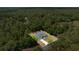 An aerial shot showcases a well-maintained home featuring a private pool amidst lush greenery at 9835 Sw 207Th Cir, Dunnellon, FL 34431