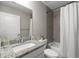 Bathroom featuring a tiled shower/tub, granite countertop, and sleek fixtures at 9835 Sw 207Th Cir, Dunnellon, FL 34431