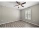 Well-lit bedroom with neutral walls, laminate flooring, window with shutters, and ceiling fan at 9835 Sw 207Th Cir, Dunnellon, FL 34431