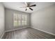 Neutral bedroom showcasing a ceiling fan, and shuttered window at 9835 Sw 207Th Cir, Dunnellon, FL 34431