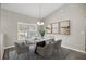 Elegant dining room features a modern table with gray chairs and stylish artwork at 9835 Sw 207Th Cir, Dunnellon, FL 34431