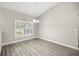 Bright, empty room showcasing a vaulted ceiling and ample natural light through shuttered windows at 9835 Sw 207Th Cir, Dunnellon, FL 34431