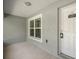 Inviting front porch of a home with a white door and a clear 'No Soliciting' sign at 9835 Sw 207Th Cir, Dunnellon, FL 34431